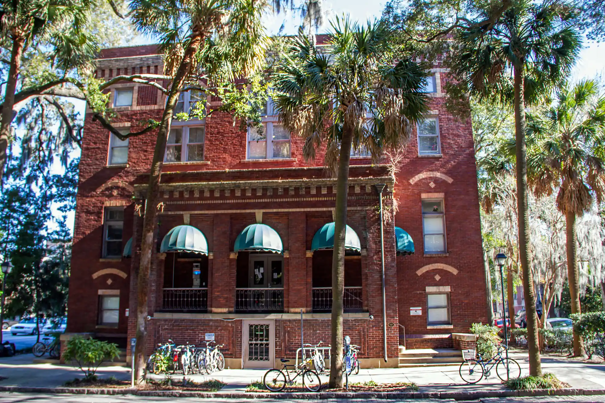 Pulaski Square, read building with bikes in Savannah