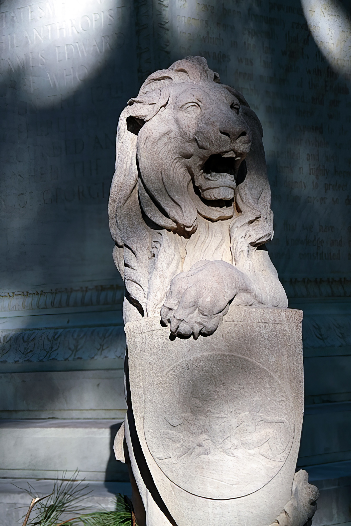 Shield holding lion statue