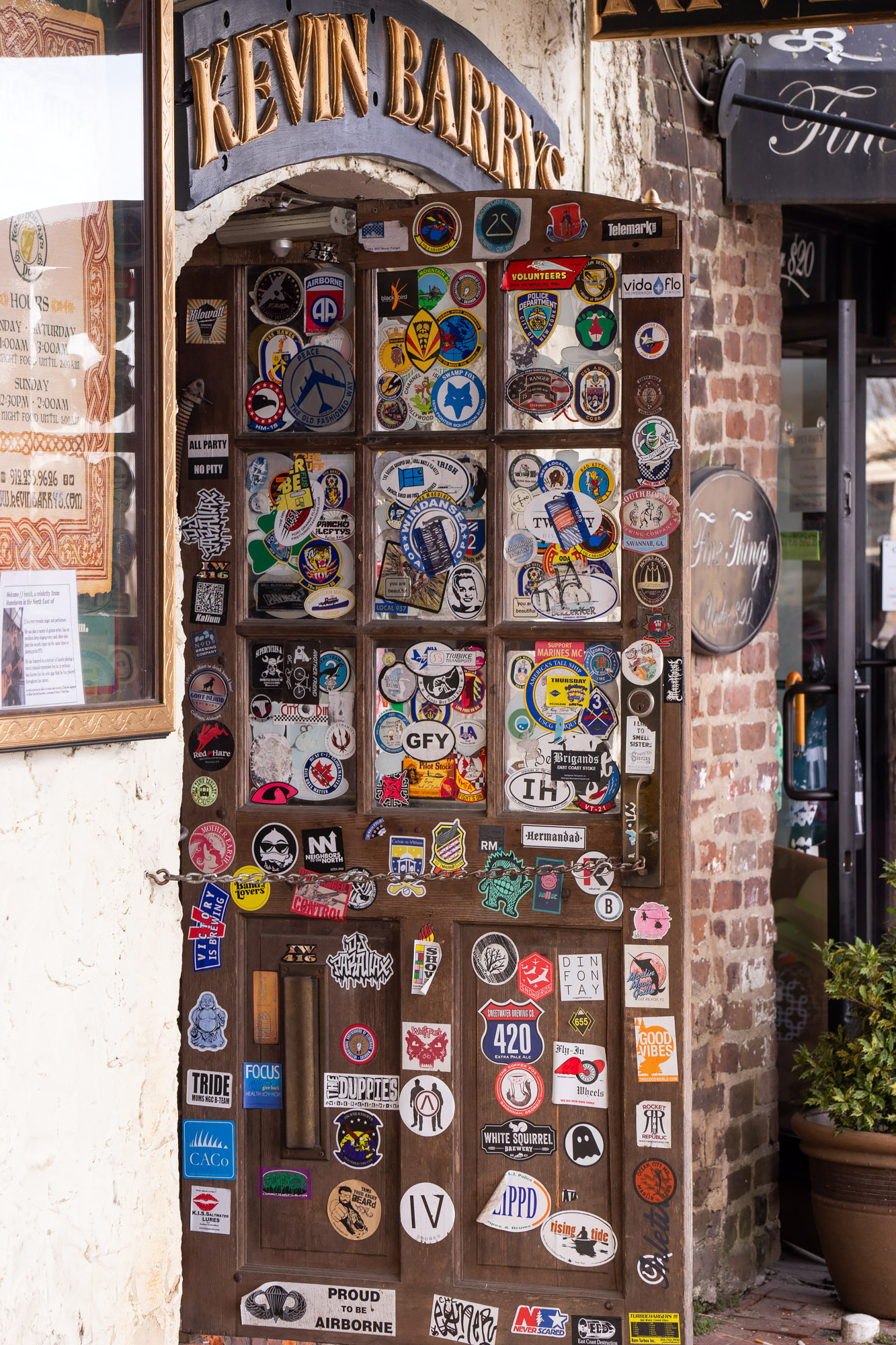 Door covered in stickers at Savannah's River Street